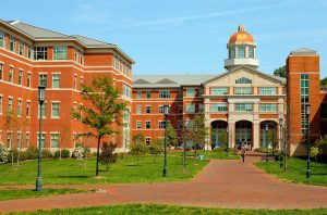 Photography of Charlotte NC's University of North Carolina at Charlotte campus (UNC Charlotte). UNCC, a public university located in northeast Charlotte, is part of the University of North Carolina higher education system. Opened in 1946, the campus has experienced explosive growth in recent years, including the addition of its Charlotte Research Institute campus and a football team. Photo shows the College of Health and Human Services Building.